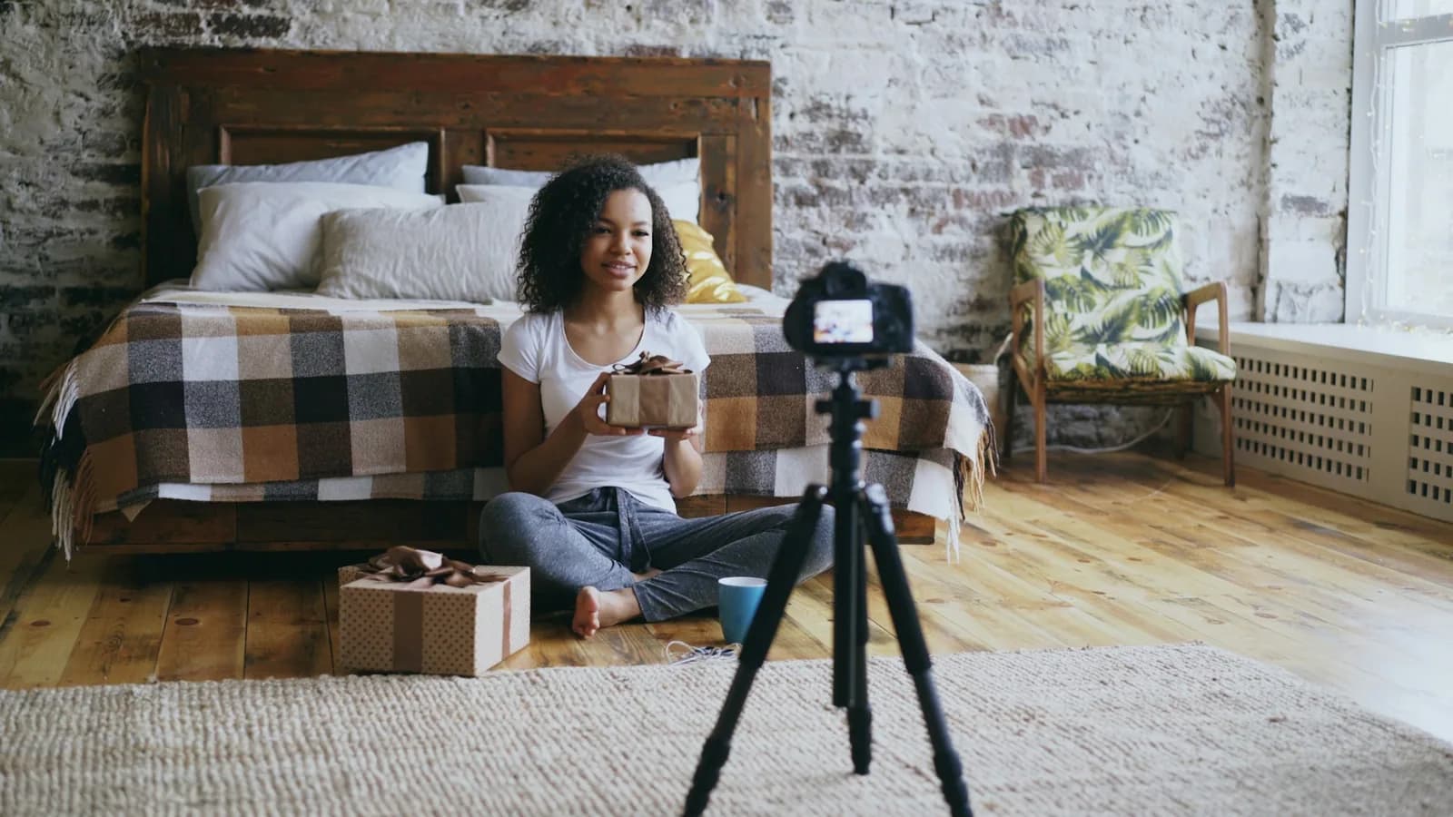 Content creator filming an unboxing video with a camera mounted on a tripod